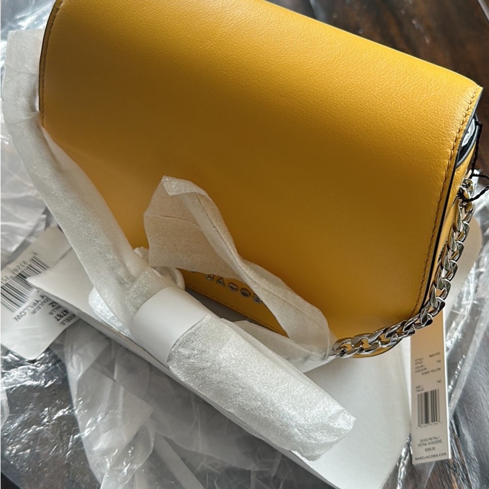 It is a brand new Marc jacob yellow bag with silver chain